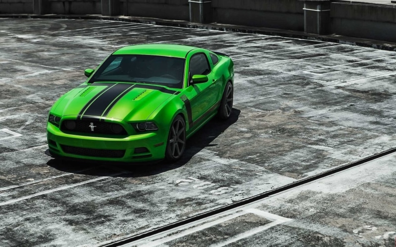 close-up, stationary, ford, motor vehicle, outdoors, coupe, concrete, transportation, black, street, green cars, architecture, isolated color, mode of transportation