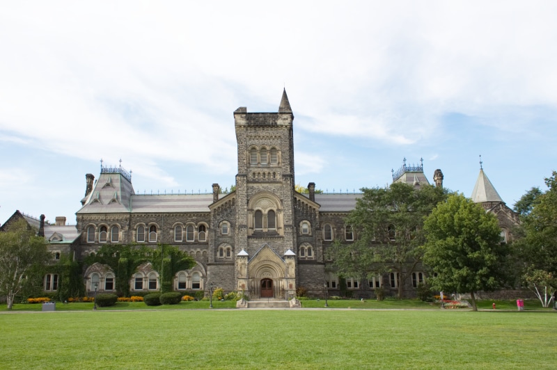 grass, lawn, incidental people, day, plant, tourism, cloud - sky, building, the past, education, travel destinations, outdoors, campus, sky, spire, government
