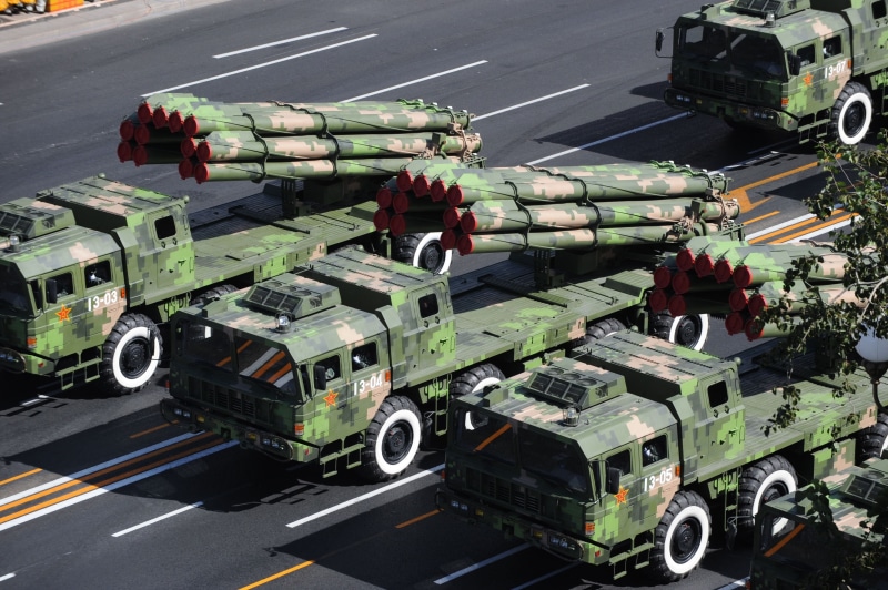 car, day, china, launcher, motion, aggression, mode of Transport, mrls, nature, street, outdoors, sign, incidental people, green, rocket, military, firefighter