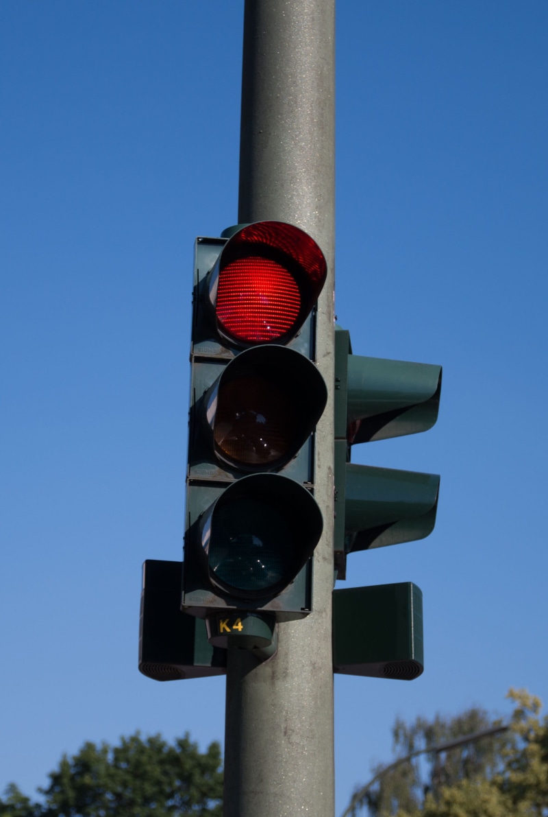 outdoors, red, traffic control, clear sky, stoplight, sign, low angle view, semaphore, road sign, dangerous, 2K, safety, guidance, red light, sky, risk