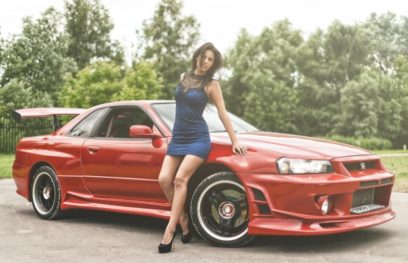 beautiful woman, fashion, transportation, motor vehicle, women with cars, skyline, day, land vehicle, blue dress, smiling, car, s, leisure activity, mode of transportation