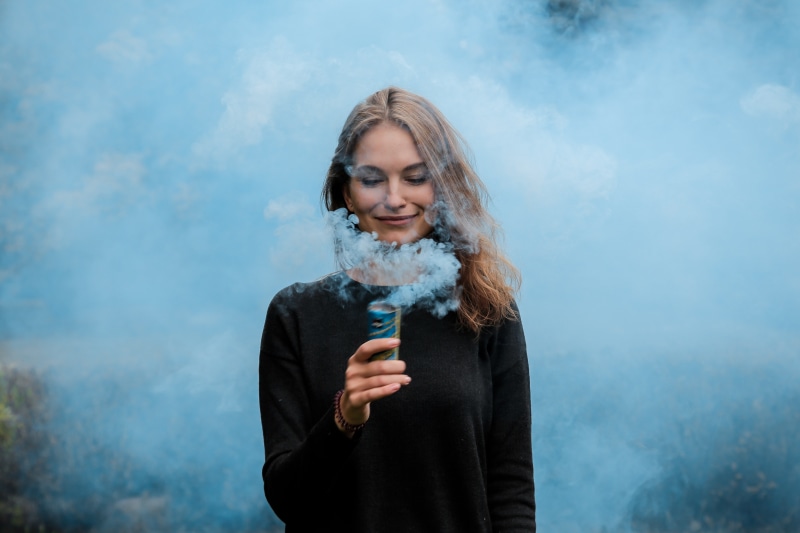 standing, smoking issues, front view, hairstyle, one person, communication, bad habit, sign, young adult, holding, risk, lifestyles, 5K, activity, warm clothing