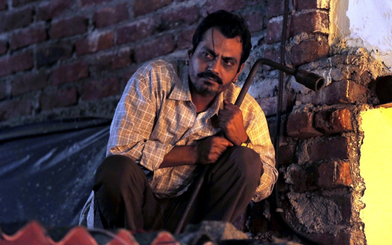 smoking - activity, mid adult men, brick, white, bollywood, clothing, siddiqui, raghav, nawazuddin, outdoors, shirt, brick wall, s, sport, beige, weapon