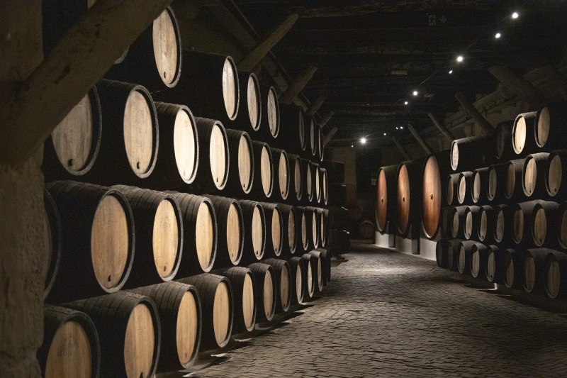 building, food and drink, architecture, no people, warehouse, alcoholic, cava, refreshment, order, illuminated, winemaking, winery, barrels, wine, in a row