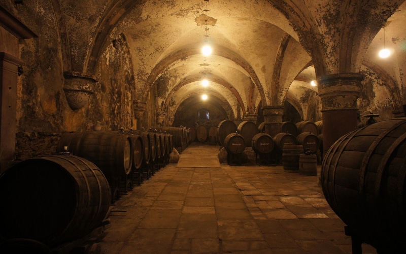 wine cask, barrels wine cellars, wood - material, wine cellar, alcohol, barrel, illuminated, lighting equipment, food and drink, arch, winery, in a row