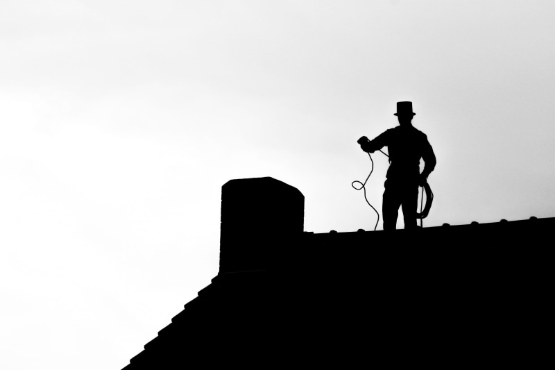 outdoors, craft, house roof, full length, real people, lifestyles, built structure, roof, chimney sweep, chimney, dusk, low angle view, rope, cylinder