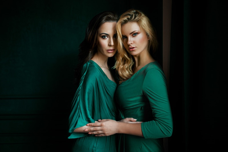 people, two people, indoors, hair, young women, couple - relationship, beauty, standing, women, long hair, adult, black background, waist up, looking at camera