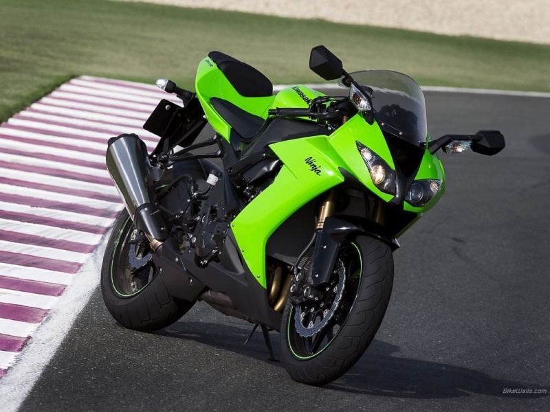 parking, stationary, day, land vehicle, black color, mode of transportation, close-up, nature, Kawasaki ninja, outdoors, focus on foreground, jeans, no people