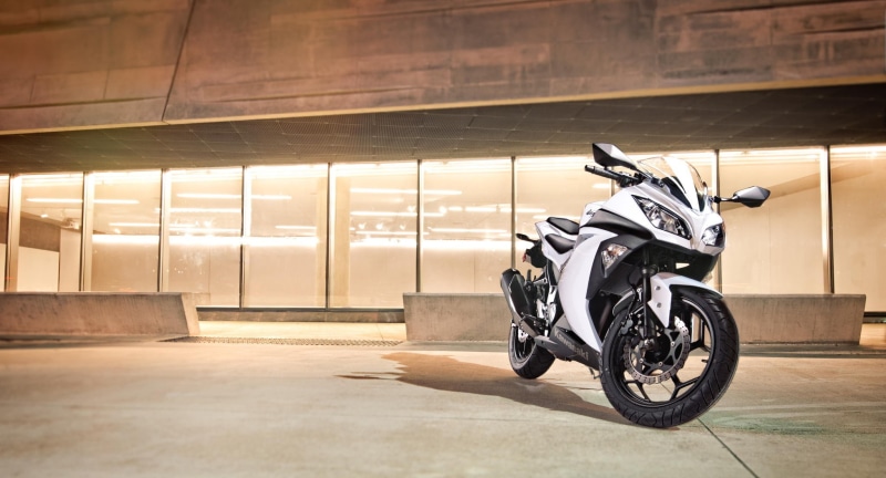 motion, wheel, architecture, motorcycle, transportation, city, helmet, speed, land vehicle, headwear, activity, full length, sports equipment, mode of transportation