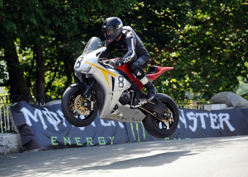 mode of transportation, biker, motorcycle racing, motor racing track, competition, headwear, vehicle, helmet, jumping, crash helmet, sports, extreme sports