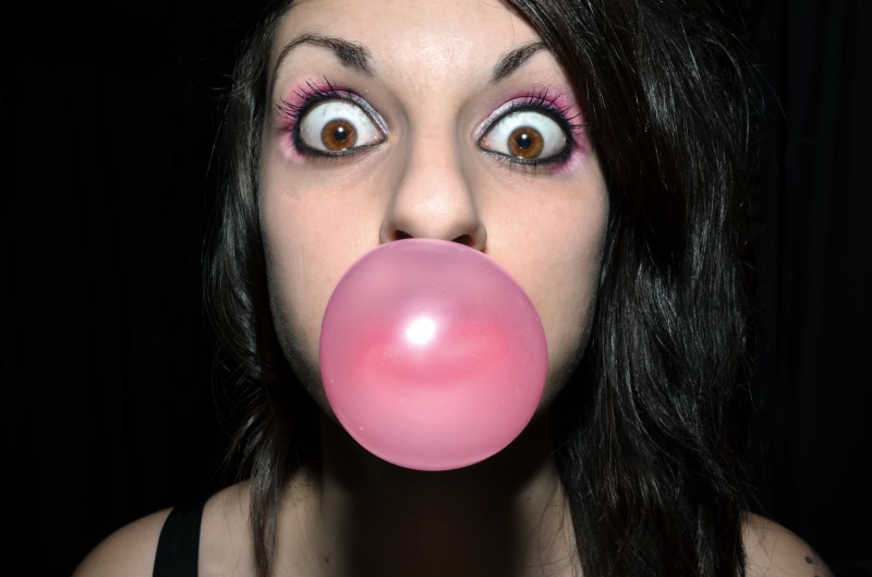 body part, black background, human face, brunette, bubbles, brown eyes, women, headshot, model, bubble gum, studio shot, indoors, bare shoulders, looking at viewer