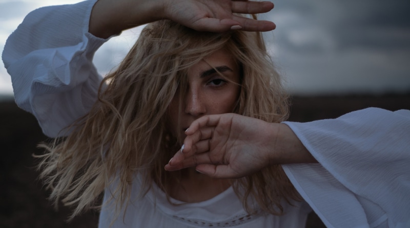 dark eyes, depression - sadness, teenager, portrait, women outdoors, people, blonde, hair in face, terrified, freckles, emotion, hand, young women, violence