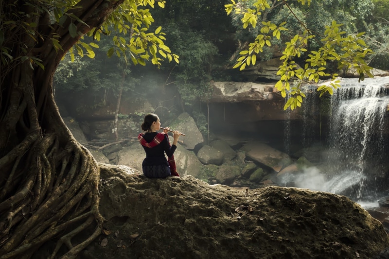 sitting, young women, plant, tree, flowing water, rock - object, leisure activity, young adult, rock, flute, adult, one person, women outdoors, solid, beauty in nature