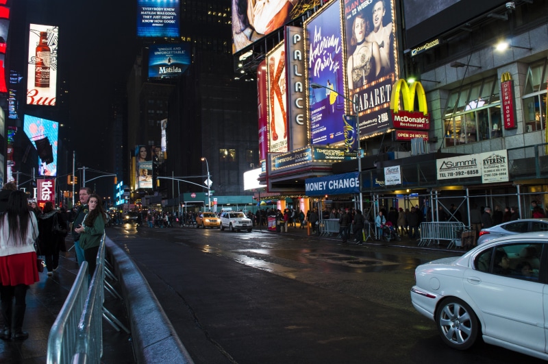 architecture, building exterior, car, motion, incidental people, outdoors, city, dark, office building exterior, building, night, travel, sign, times square