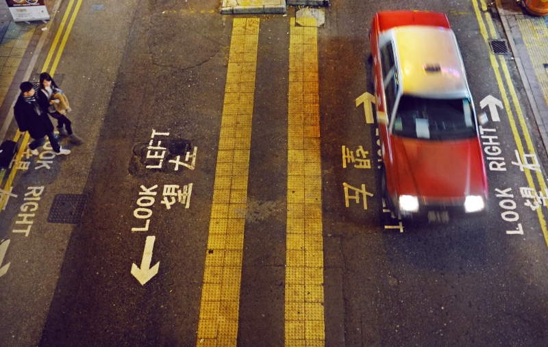speeding, standing, road, mode of transportation, nighttime, transportation, taxi, editorial, driving, symbol, right, woman, sedan, walking, red, no people