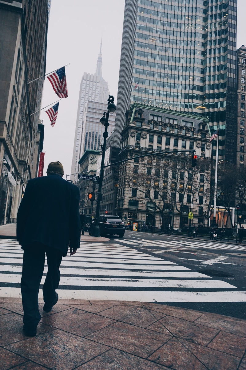 concrete, real people, road, street, rear view, wearing, built structure, flags, full length, travel, pedestrian crossing, suit, business, independence