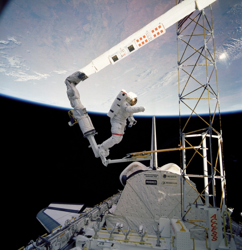 water, mode of transportation, outdoors, tether, spacewalk, navy, low angle view, flying, maintenance, no people, architecture, pack, travel, building exterior