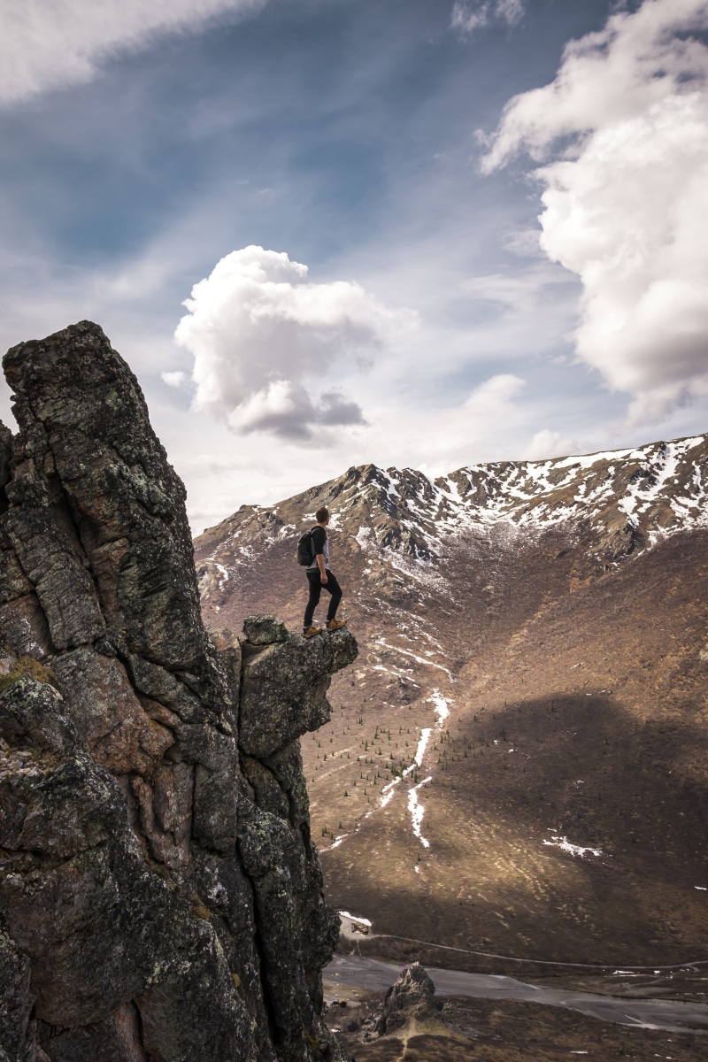 facing, cloud - sky, white, male, cloud, lifestyles, blue, rock - object, leisure activity, standing, adventure, rugged, activity, wilderness, clouds, men