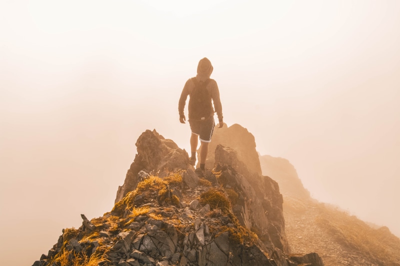full length, sunrise, mist, top, fog, vacations, walking, adult, rock, sunset, cloud, view, outdoors, sunlight, mountain range, male, hill, trip, adventure