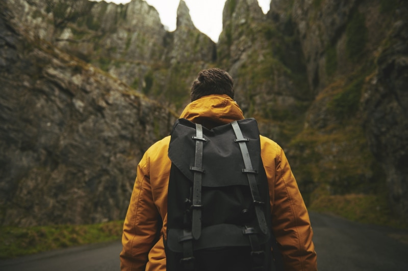 real people, yellow, rear view, nature, person, recreation, activity, day, 2K, man, backpack, one man only, outdoors, rocky, hiking, road, waist up, wearing
