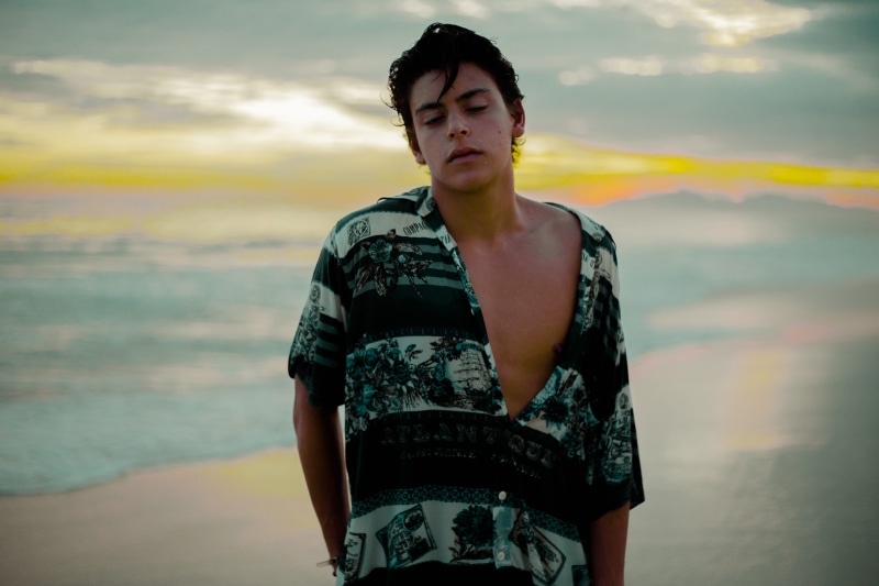 sky, men, beach, leisure activity, daytime, one Person, man in black, waist up, cloud - sky, standing, fashion, outdoors, casual clothing, person, caucasian Ethnicity