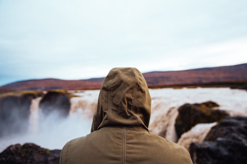 road trip, beauty in nature, rocks, man, focus on foreground, outdoor, waterfall, rear view, lifestyle, solid, hood, recreational pursuit, land, rock, day