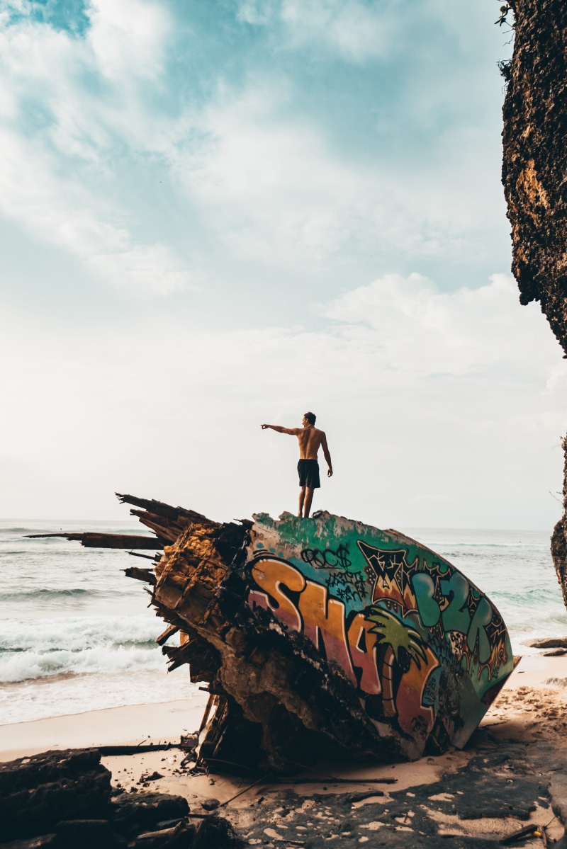 outdoors, fun, cloud - sky, day, leisure activity, horizon over water, one person, clouds, explore, enjoyment, focus, landscape, graffiti, photography