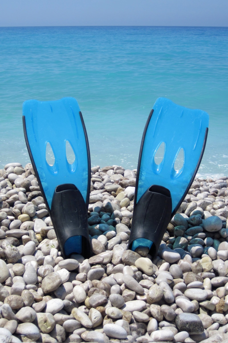 sea, fins, pebble, outdoors, sport, holiday, beauty in nature, solid, no people, flipper, fun, scuba, tropical, blue, pair, stone - object, vacation, stone