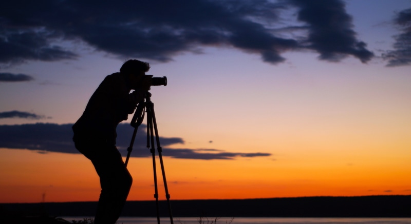 people, slr camera, occupation, water, professional occupation, home video camera, telescope, equipment, activity, cloud - sky, photography themes, technology