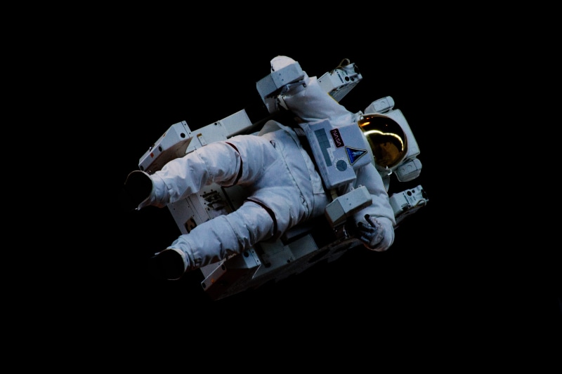 spaceship, black background, mid adult men, full length, indoors, black, studio shot, excess, people, astronaut, mid adult, nasa, work, uniform, floating