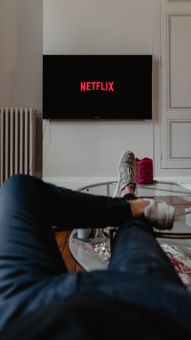 holding, personal perspective, illuminated, watching, table, movie, sofa, tech, domestic room, series, relax, lying, human body part, man, relaxation, low section