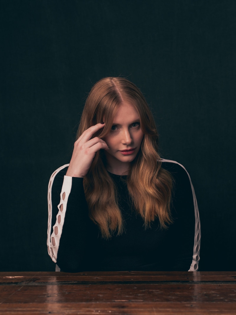 actress, human hair, 4K, contemplation, waist up, redhead, long hair, front view, black background, Bryce Dallas Howard, adult, blond hair, looking at camera