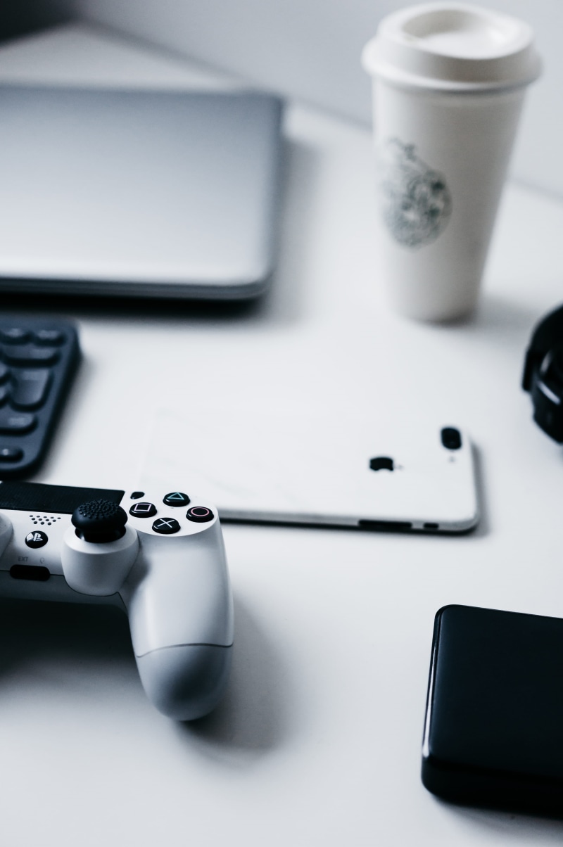 workspace, remote Control, coffee cup, equipment, black Color, no People, mobile Phone, cup, playstation, laptop, minimalist, communication, gamer, white