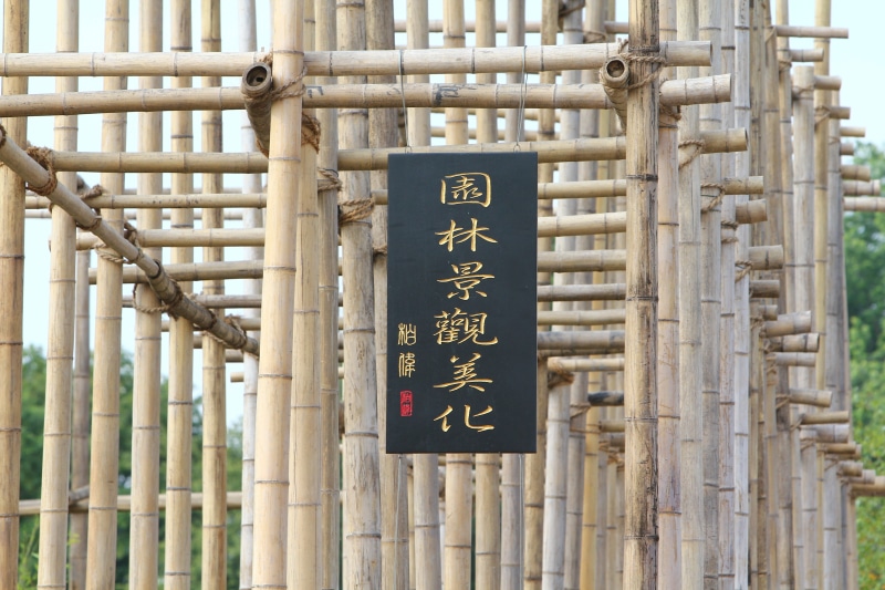 bamboo, no people, building, architecture, sign, information sign, day, outdoors, linkage, scaffold, information, gate, western script, text, communication