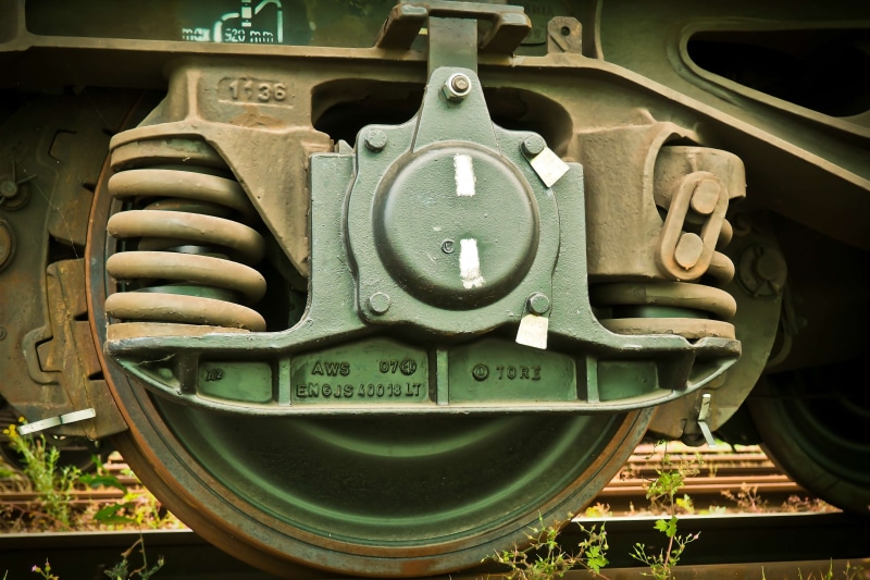 wheels, communication, green color, metal, outdoors, loco, number, connection, mode of transportation, chassis, train - vehicle, close-up, no people, public transportation