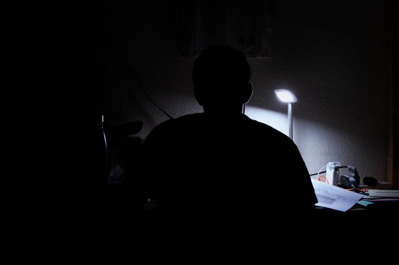 real people, table, night owl, schoolwork, work, office, illuminated, one person, communication, electric lamp, night, lighting equipment, computer