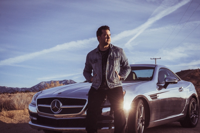 sky, hood, adult, casual clothing, mode of transportation, mercedes benz, men, one person, jean, front view, road trip, land vehicle, s, leisure activity