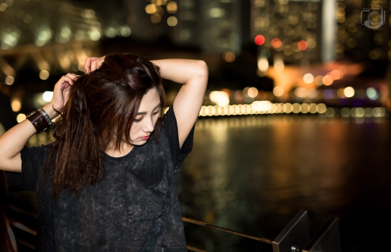 railing, focus on foreground, 5K, arms up, young adult, young women, Asian, brunette, hairstyle, beautiful woman, T-shirt, adult, hand in hair, illuminated