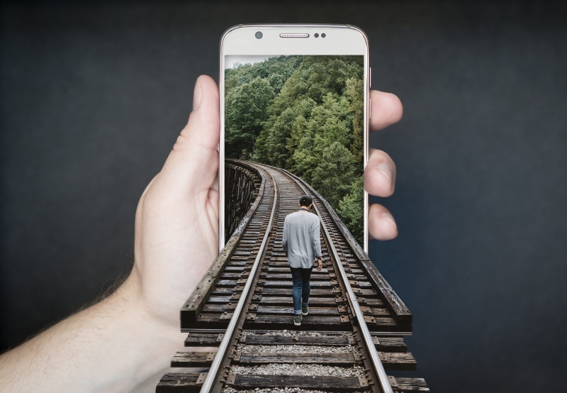 charming, black, track, 2K, outdoors, lifestyles, white, illusion, Manipulation, seemed, mobile phone, risk, people, photoshop, one person, rail, hand
