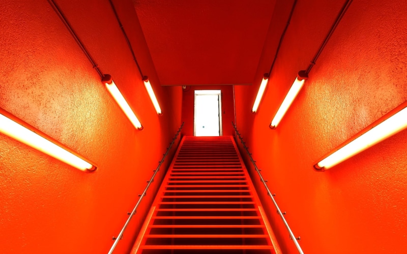 orange, direction, wall - building feature, lighting equipment, day, ceiling, moving up, building, no people, diminishing perspective, indoors, staircase