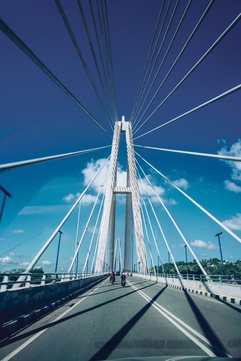 suspension bridge, bridge - man made structure, government, bridge, direction, diminishing perspective, road, day, built structure, kalimantan timur, cable
