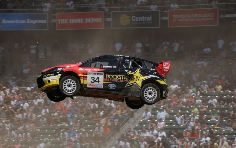sports race, sport, real people, communication, black, competition, car, motion, number, mode of transportation, red, sign, rally, crowd, speed, incidental people