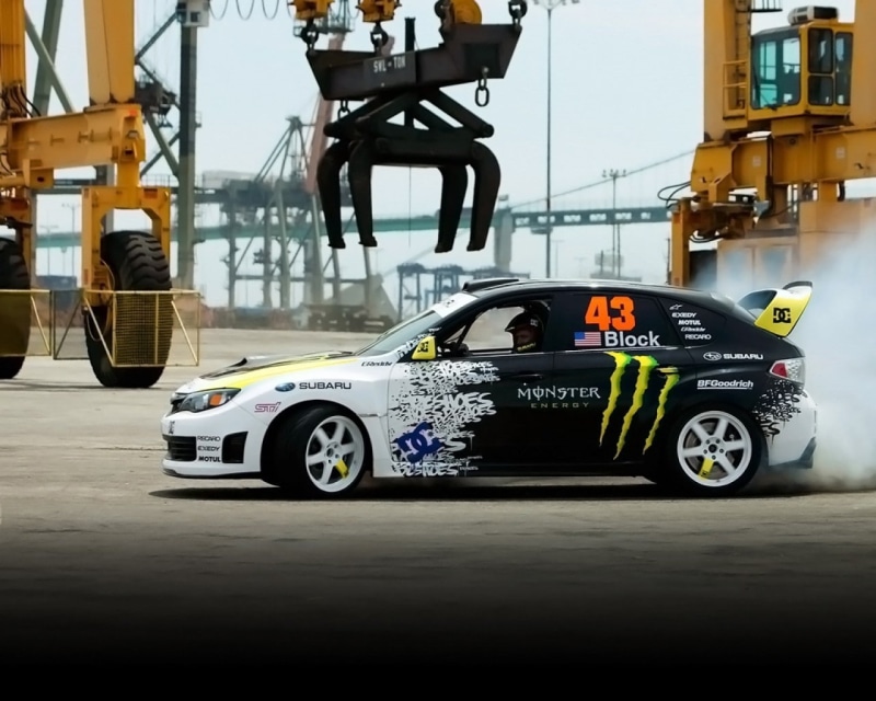 industry, no people, road, city, 720P, wheel, outdoors, glass - material, rally cars, motion, land vehicle, architecture, Ken Block, tire, day, motor vehicle