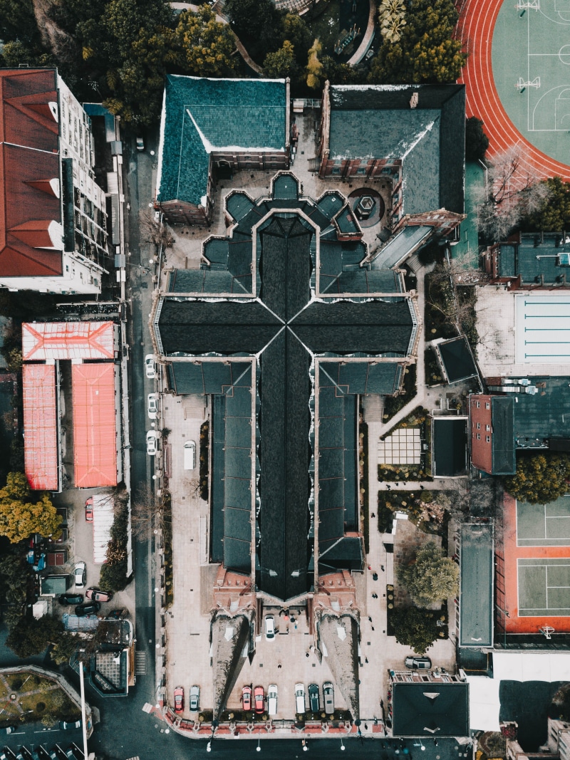 photography, mode of transportation, from above, basketball, building, surrounded, courts, belief, built structure, shape, drone, aerial view, aerial, buildings