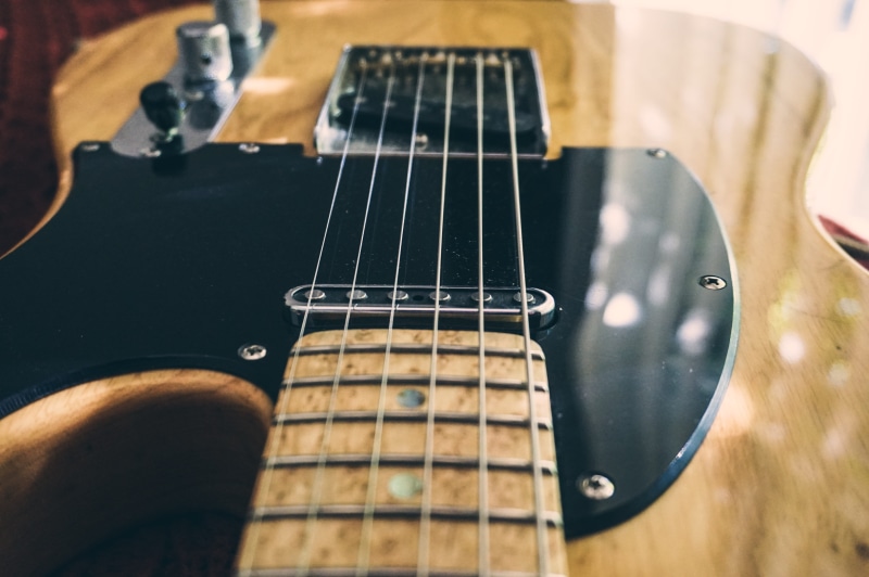 music, musical instrument, close-up, day, musical instrument string, gibson, electric guitar, musical equipment, indoors, telecaster, still life, fender
