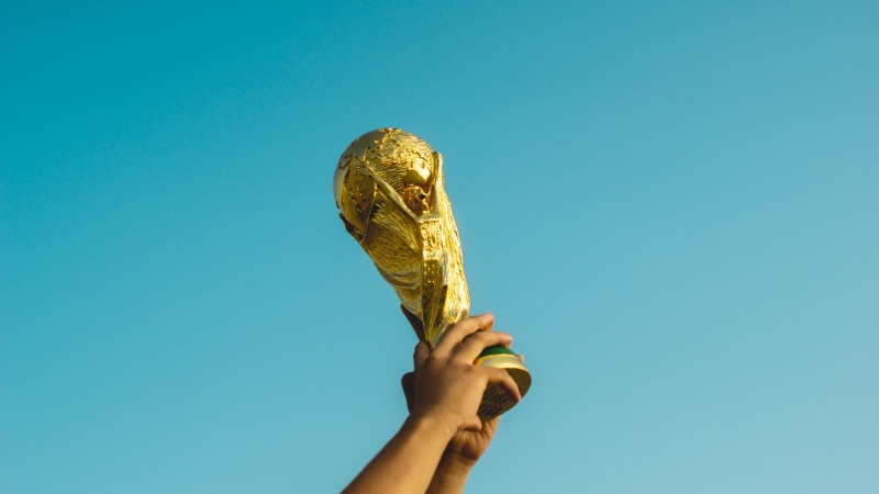colored background, gold, unrecognizable person, football, world cup, low angle view, champion, sky, food and drink, pre world cup, hand, fifa, raising