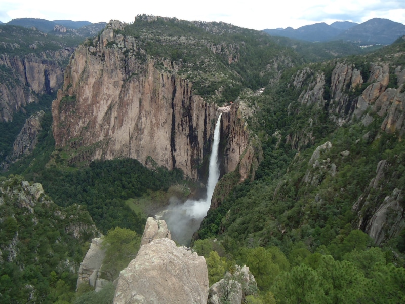 long exposure, flowing water, mountain, water fall, tree, beauty in nature, no people, plant, waterfall, solid, power in nature, formation, water, rock formation