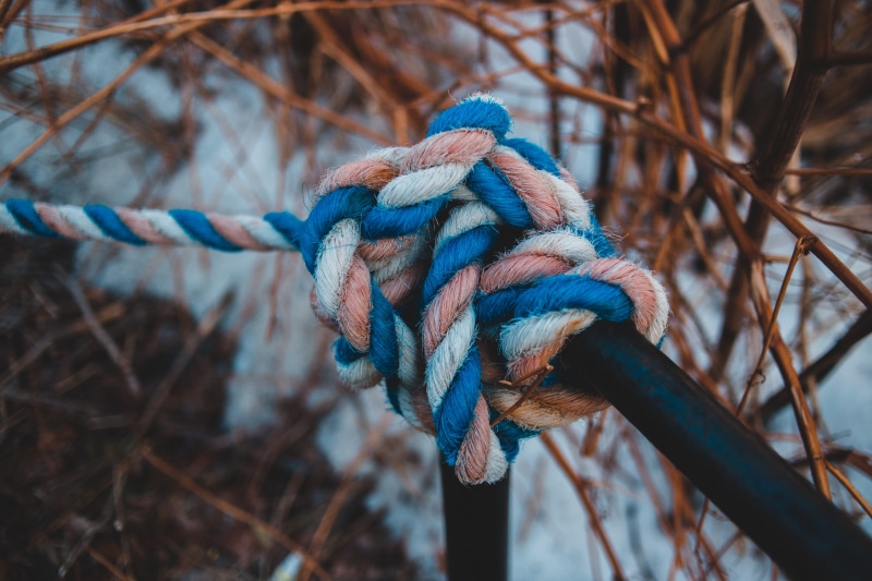 cone, tied up, tire, heart, pink, white, bib, outdoors, drink, reel, 5K, no people, rope, plywood, connection, twisted, rust, day, pattern, intersection