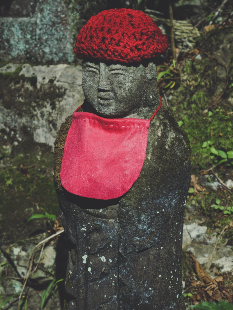 fashion, tree trunk, art and craft, person, bonnet, hood, nature, day, craft, robe, red, grey, close-up, human representation, cap, evening dress, land