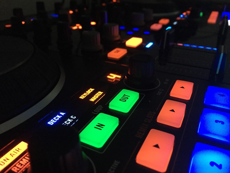 no people, multi colored, multicolored, celebrate, control, dance, dance club, desk, party, equipment, mixer, indoors, western script, black, text, focus on foreground
